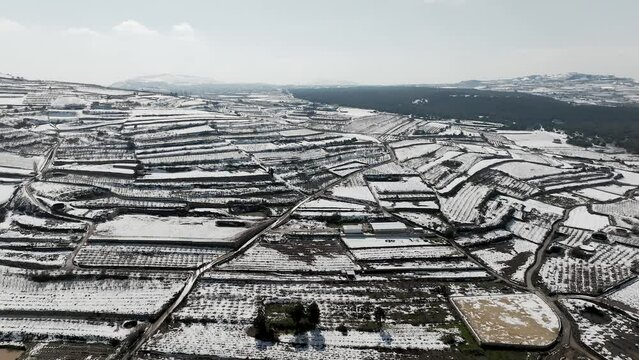 Agriculture terrace fields covered with fresh white snow, Aerial view