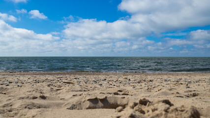 Close-up of the sand on a beach with the sea in the background