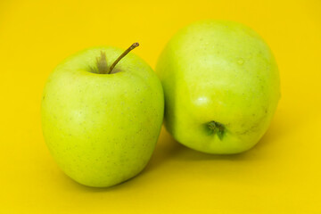 apple isolated on yellow background. Clipping path.