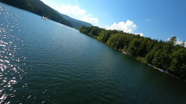 dynamic aerial fpv shots of sailing boats at the lake packer stausee in styria, austria