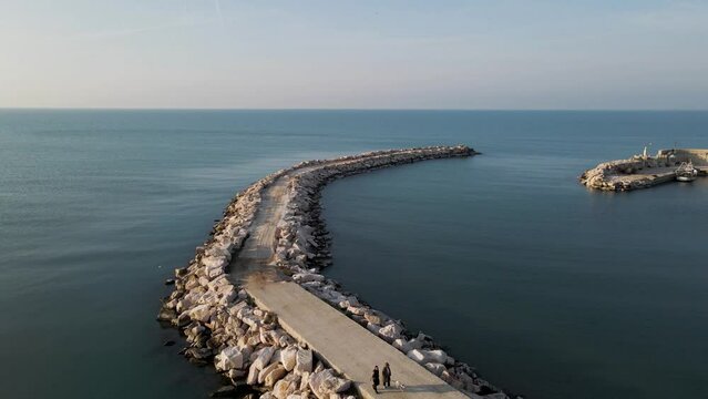 Aerial view of a breakwaters in Peschici harbour and port, Gargano Natural Park, Puglia, Italy.