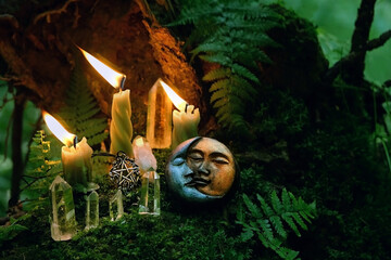 candles, crystals, symbolic moon amulet on dark forest background. pagan Wiccan, Slavic traditions...