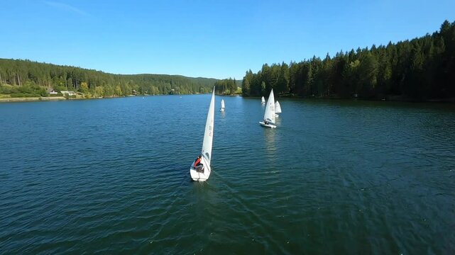 dynamic aerial fpv shots of sailing boats at the lake packer stausee in styria, austria