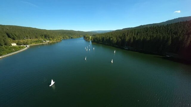 dynamic aerial fpv shots of sailing boats at the lake packer stausee in styria, austria