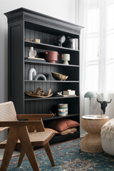 Classic black bookcase with different style decorations