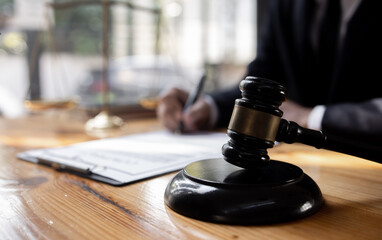 Fototapeta na wymiar lawyer working with contract agreement at table office, law and justice concept, Selective focus.
