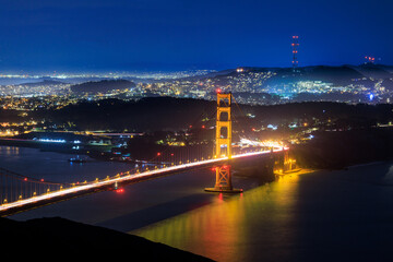 Golden Gate Bridge and lights from hilly city of San Francisco at night