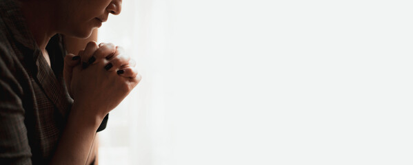 Closeup shot of a female praying at home. christian concept.