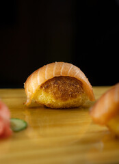 fried sushi with salmon. big piece of sushi with pink salmon