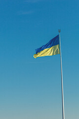 Ukrainian flag against the blue sky