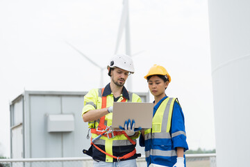 Male and female engineer wearing uniform and helmet working and discuss while control or monitoring...