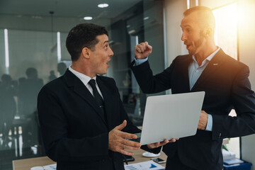 Financial analysts analyze business financial reports on a digital tablet planning investment project during a discussion at a meeting of corporate showing the results of their successful teamwork.
