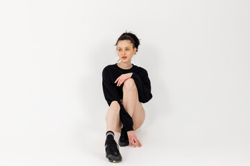 Attractive Slim Girl wearing black short top and white mini skirt and posing. Isolated on white background.