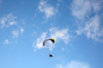 Paraglider. Flight against the background of the blue sky.