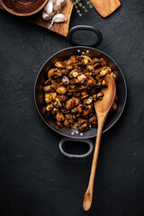 Sauteed mushrooms with onion and thyme in frying pan, vegan meal