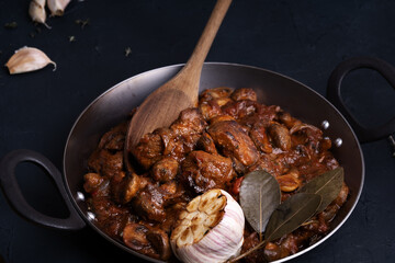 Sauteed meat and mushrooms with onion and thyme in frying pan, beef bourguignon