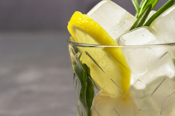 Lemon and pieces of ice in a glass. Part of the frame.