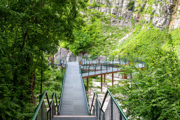 Okatse (Kinchkha) Waterfall viewing platform and boardwalks in the forest over the Satsikvilo...