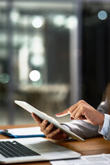 Work smarter, work better. Cropped shot of a businesswoman using a digital tablet and laptop at her...