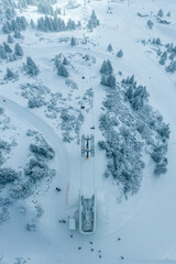 chair lift from above in fresh snowy winter in tourist ski resort