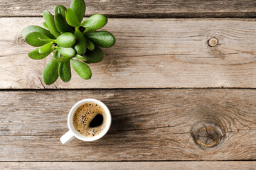 Small coffee cup on wooden table. Office desktop concept