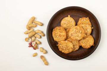 Homemade cookies on a plate and peanuts.