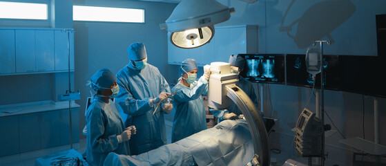 The medical team discussed the surgical options with the patient before proceeding with the operation. Surgeons team operating a patient in the operating room at the hospital