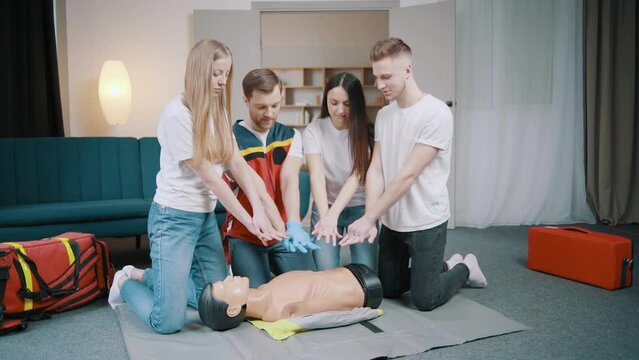 First aid resuscitation, CPR training. Students study in front of a dummy