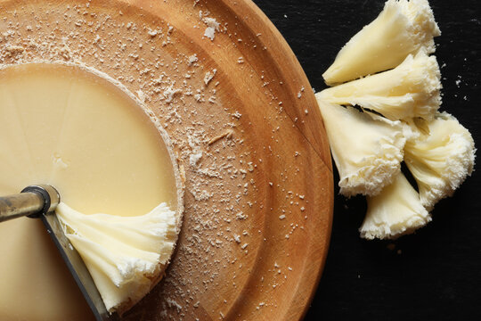 Photography of girole machine and tete de moine cheese on slate
