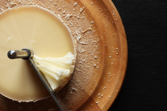Photography of girole machine and tete de moine cheese on slate