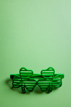 St. Patrick 's Day. glasses in form of clover leaves on a green background with copy space