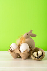 easter bunny and eggs on a green background, front view, copy space, easter concept