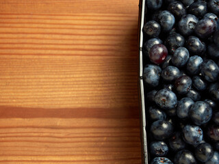 Freshly picked blueberries in a white vintage ceramic bowl. Selective focus, Free text space.