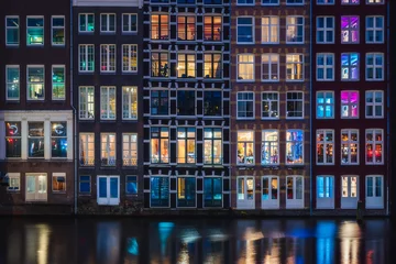 Foto op Aluminium Colorful window of the traditional riverside houses at night in Amsterdam, Netherlands © Sen