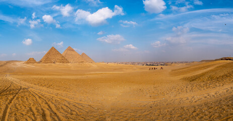 Fototapeta na wymiar General panoramic view of four pyramids in Giza, Cairo, Egypt. Real view from the desert, side view.