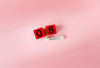 Wooden cubes with the inscription March 8 on a pink background, the inscription of a happy women's day. Ready card for the holiday, Women's Day.