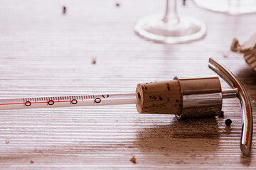A thermometer used for measuring the temperature of wine, on a wooden table
