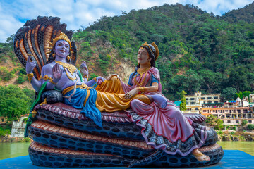 Beautiful statues of Lord Vishnu and Lakshmi at the Ganga riverbank in Rishikesh.