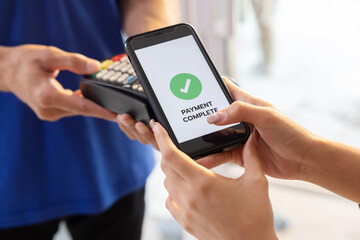 Woman Using  Phone Payment to Transfer Money to Shop Seller