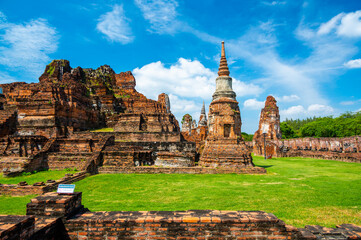 Ruins of ancient city and temples Ayutthaya, Thailand. Old kingdom of Siam. Summer day with blue sky. Famous tourist destination, spiritual place near Bangkok.