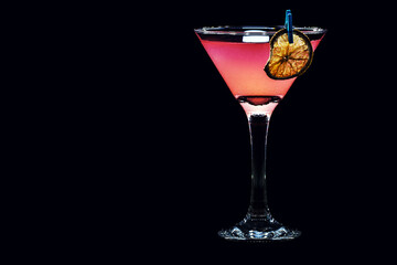 Cosmopolitan Martini, fresh in details with a touch of citrus fruit, garnished with a slice of lemon or dried orange,made with rum or gin
