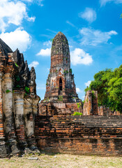 Ruins of ancient city and temples Ayutthaya, Thailand. Old kingdom of Siam. Summer day with blue sky. Famous tourist destination, spiritual place near Bangkok.