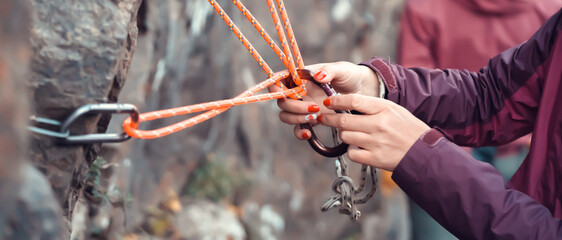 Climbing equipment, rope with carabiners on the rock.