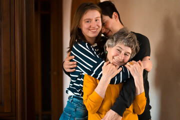 Obraz premium Family spends time together, children hug their cheerful grandmother.