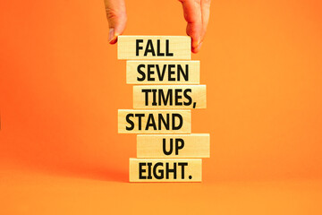 Stand up symbol. Concept words Fall seven times stand up eight on wooden blocks. Beautiful orange table orange background. Businessman hand. Business stand up concept. Copy space.