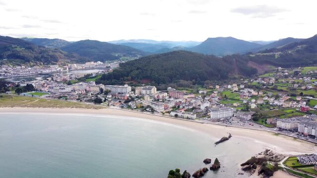 Aerial perspective of beautiful landscaped of Galicia. View of Covas city, a costal city situated in northwest of Spain.  Village at the base of the mountain. Typically Galician landscape. Backwards