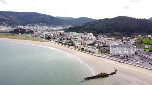 Aerial perspective of beautiful landscaped of Galicia. View of Covas city, a costal city situated in northwest of Spain.  Village at the base of the mountain. Typically Galician landscape. 