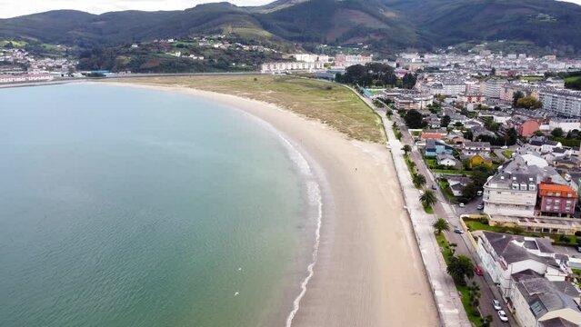 View of Covas city and beach area. Drone point of view of this Galician city , situated in northwest of Spain. In Background is Viveiro city. Drone truck left and panning right. Panoramic view.