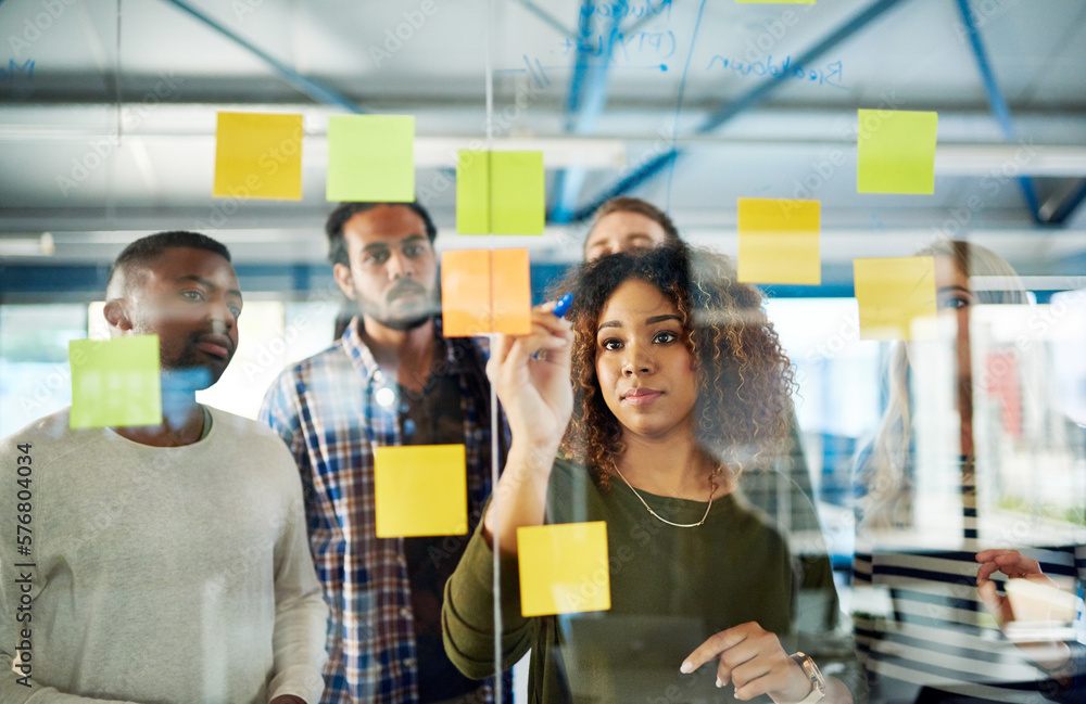 Fototapete Collaborating their way to a successful campaign. Shot of colleagues having a brainstorming session with sticky notes at work.