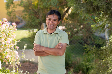 Smiling Latino man outside his house in rural area - Happy Mayan senior - Hispanic proud of his...
